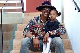 Cam Newton with his daughter